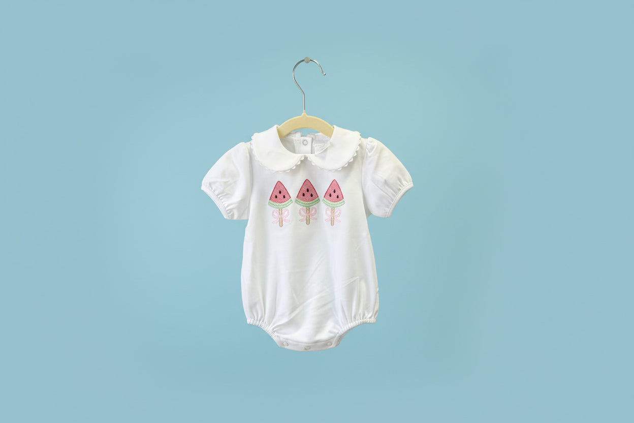White baby romper with pink watermelon design on a light blue background