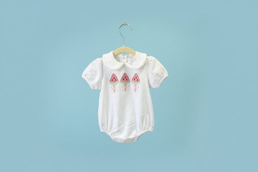 White baby romper with pink watermelon design on a light blue background